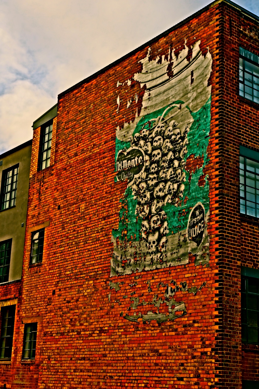 Paper graffiti pasted on the side of a building near Snow Hill train station on Livery Street, Birmingham, UK